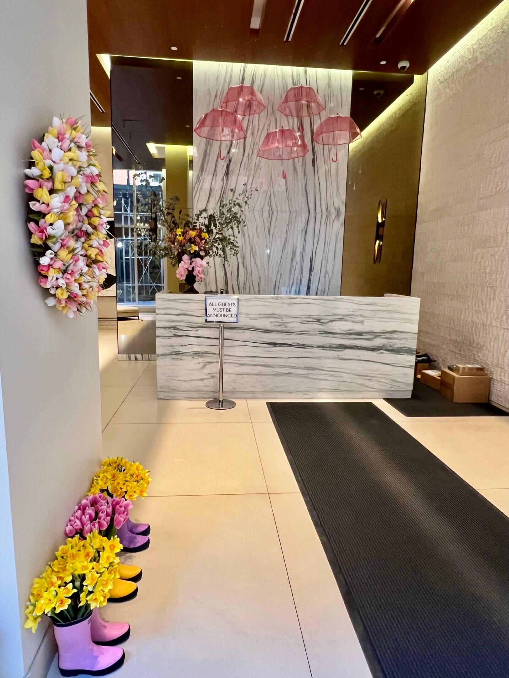 Lobby entrance with pink umbrellas and flowers.