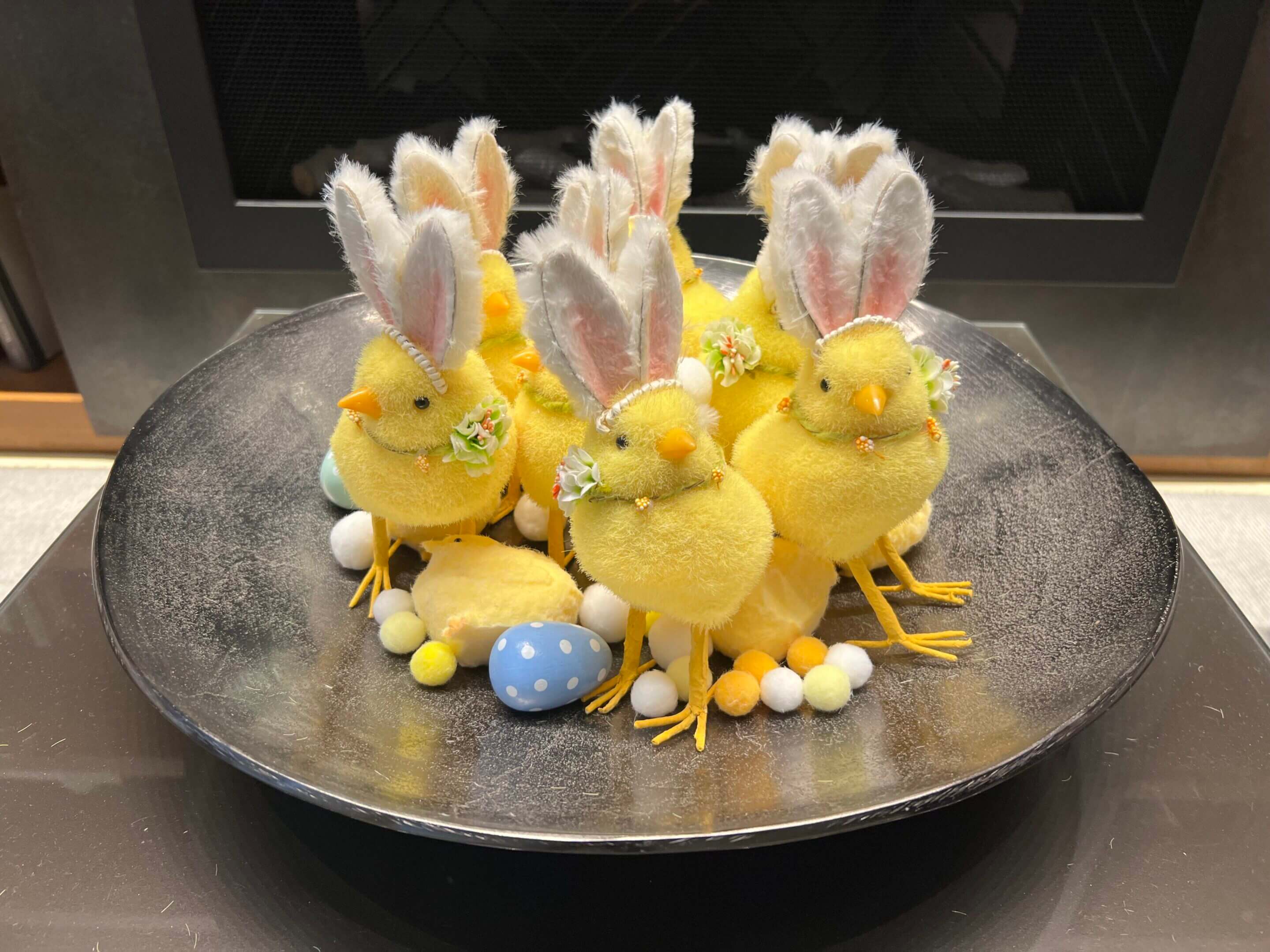 Easter chicks with bunny ears and eggs.